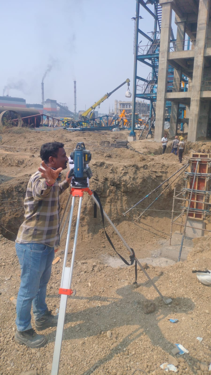 Engineer surveying on industrial site